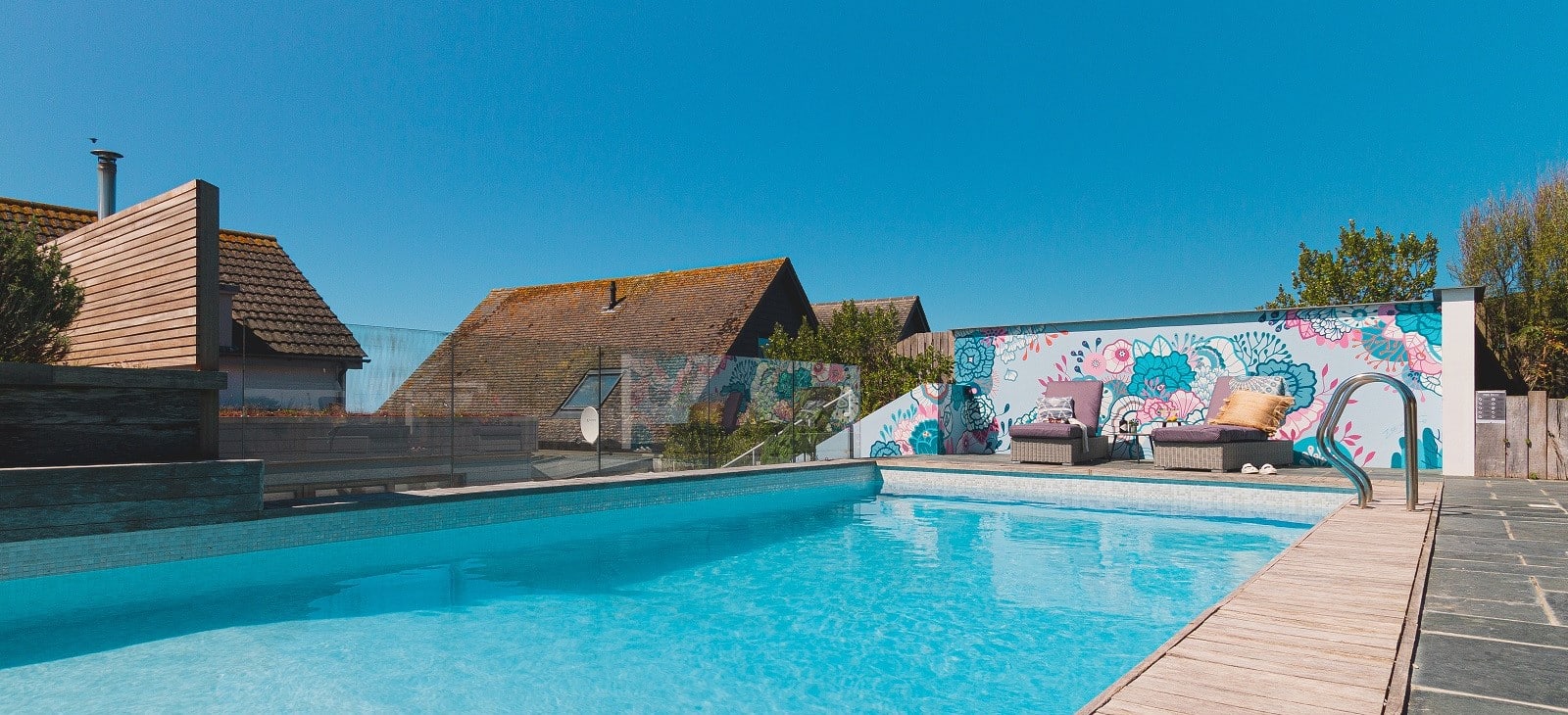 Swimming pool with floral feature wall.