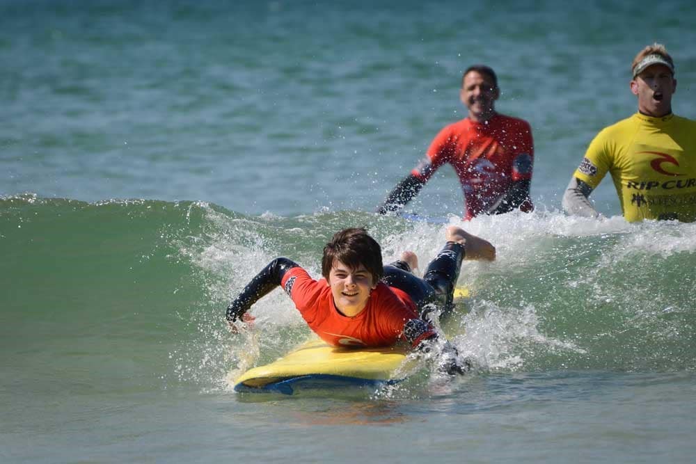 A child on a surfboard riding a wave.