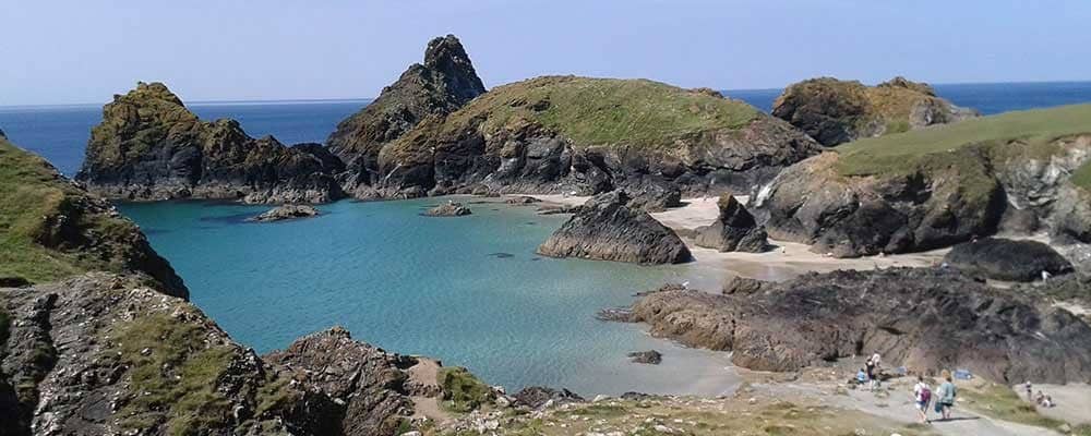 Rocky cliffs with Kynance Cove in the background.