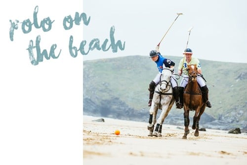 Two men on horses on a beach. 