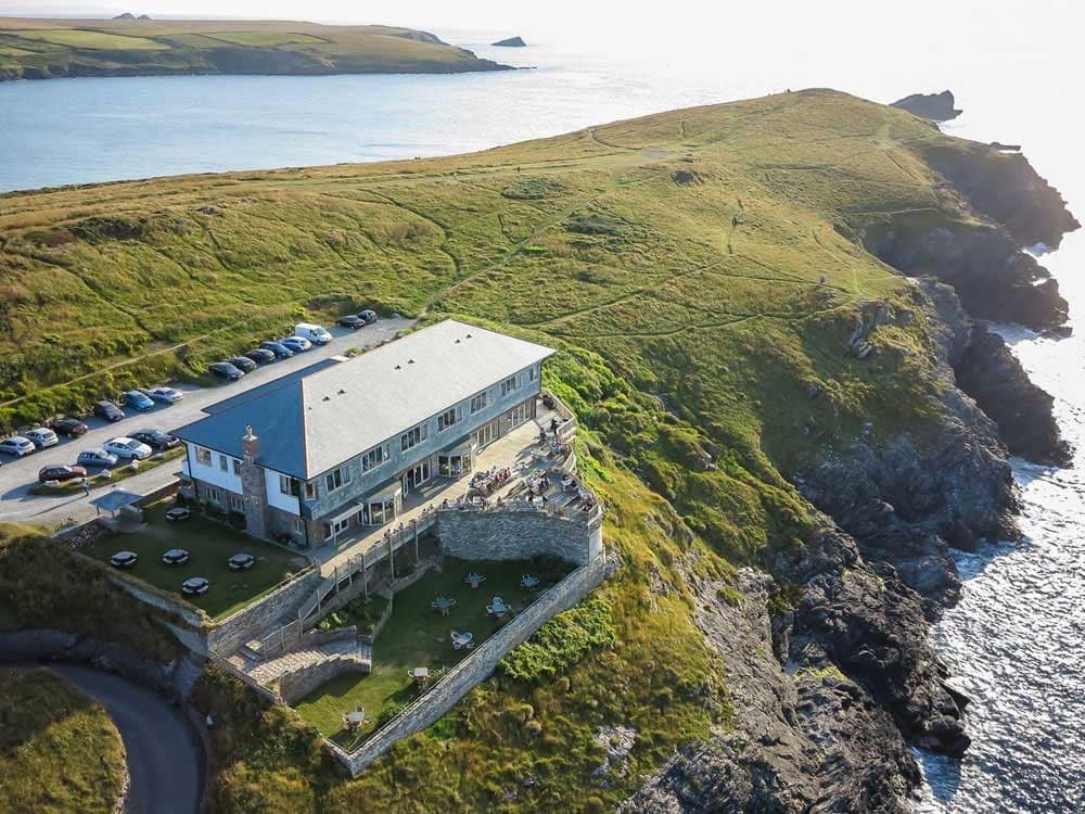 A building on cliffs overlooking the sea. 