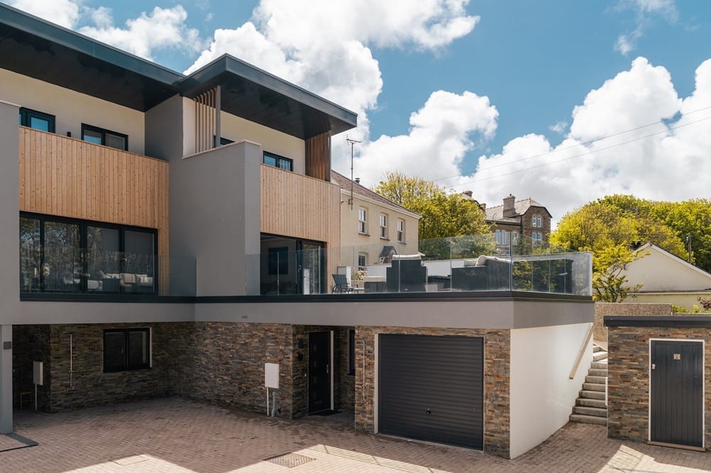 A modern building with a garage and stairs.