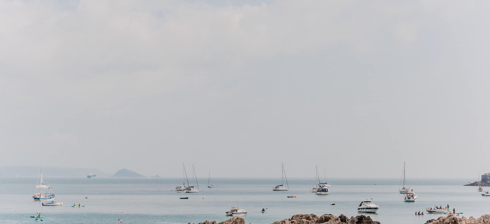 Boats on the water on a cloudy day.