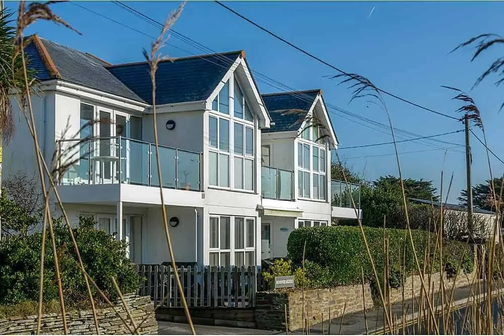 White modern houses with glass balconies.