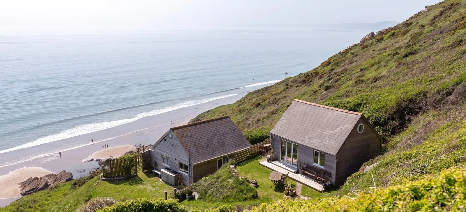 Grey wooden homes overlooking the sea.