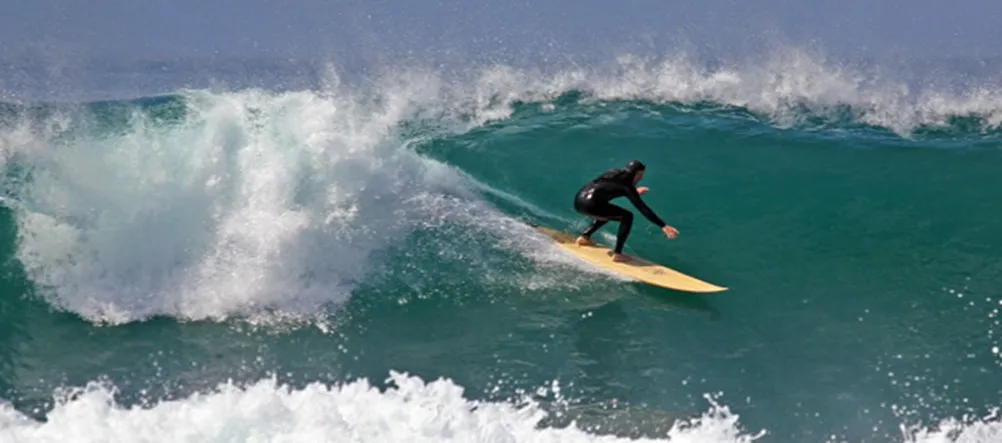 Surfer on a yellow surfboard.