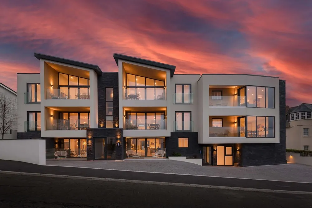 Modern apartment buildings at sunset.