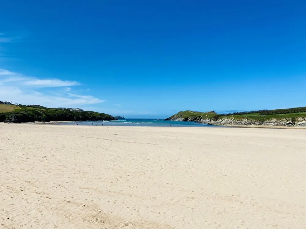 A beach surrounded by hills.