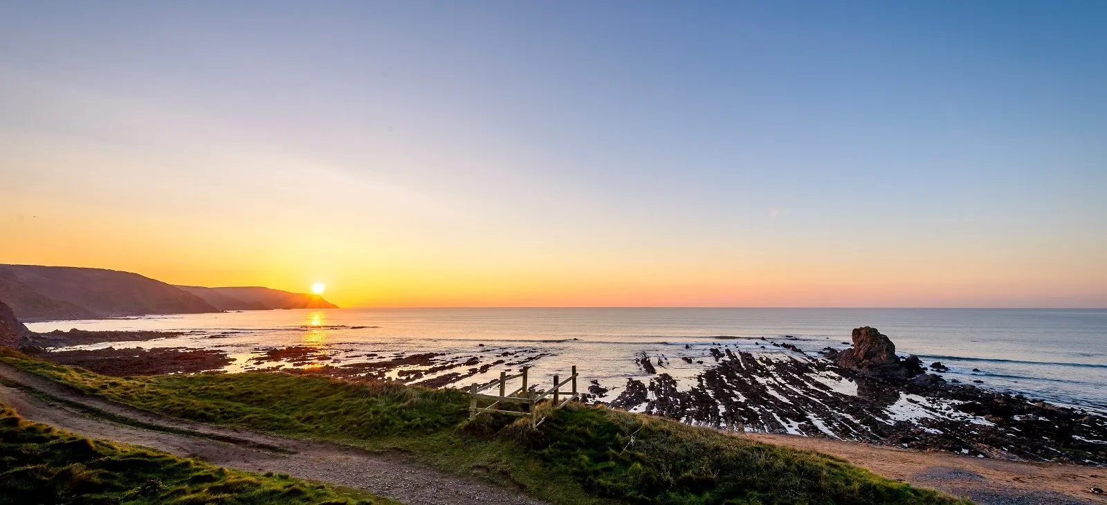 A sunset over a rocky beach.