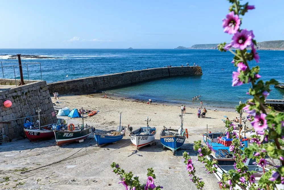 A group of boats on a beach. 