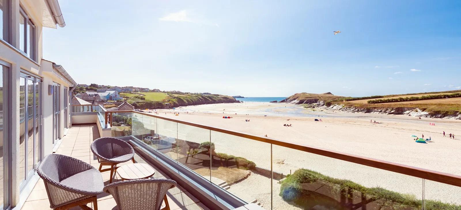 A balcony overlooking a beach.