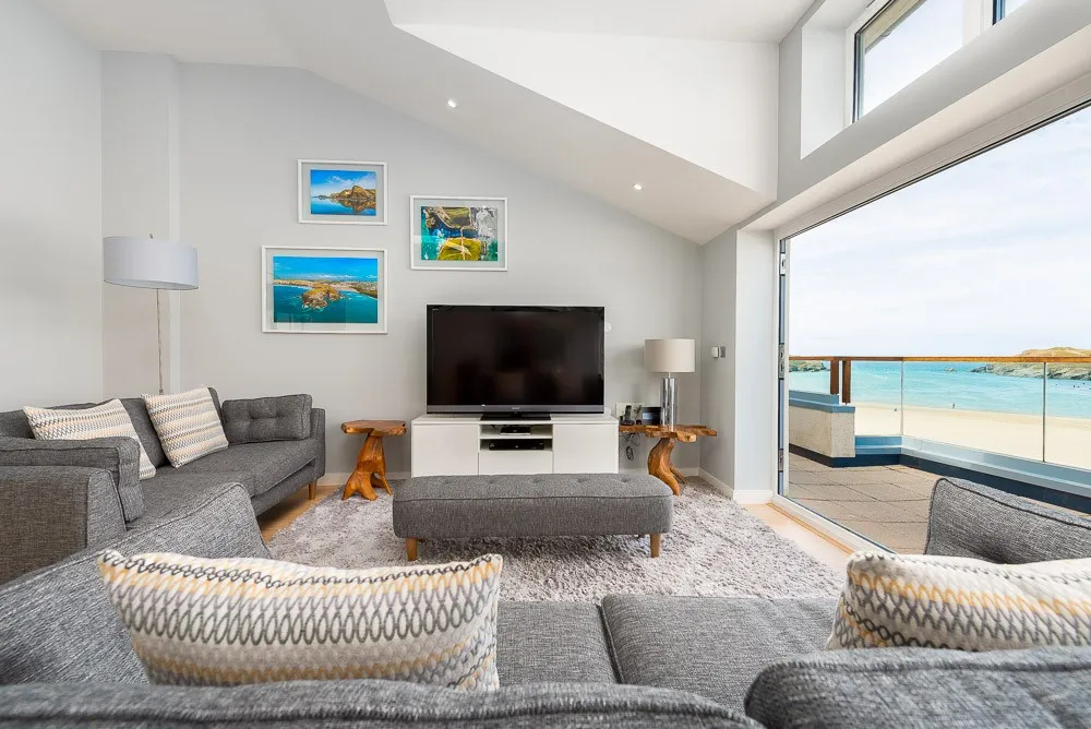 A living room with a large glass door. 