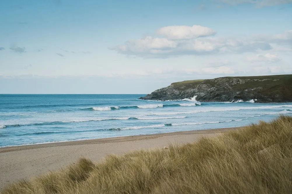 Waves rolling onto sand dunes.