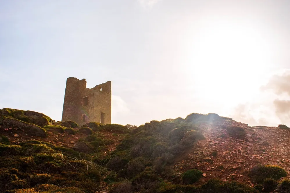 Engine house perched on cliffs.