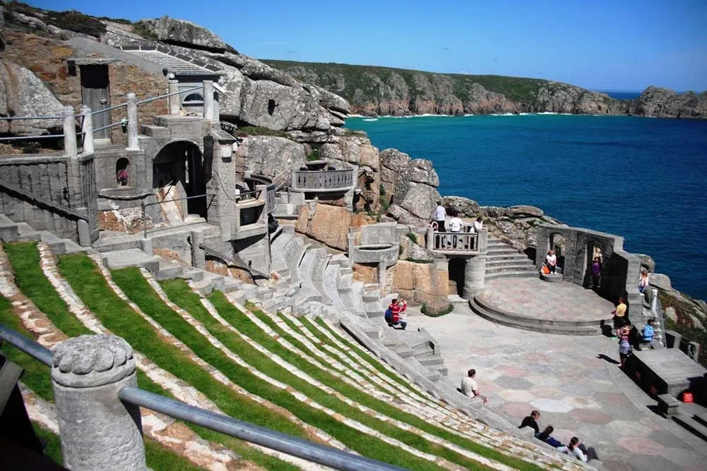 a group of people sitting on the steps of a theater.