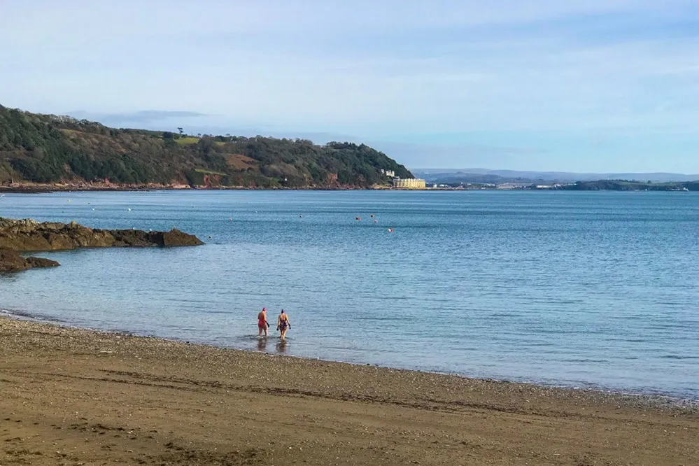 People walking into the sea.