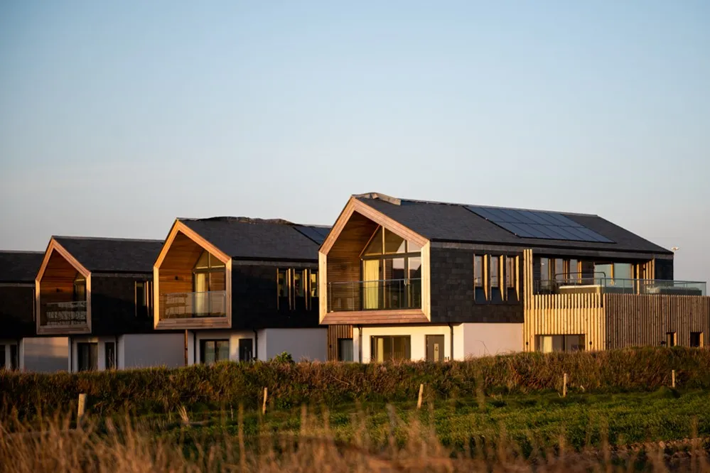 A row of houses with solar panels. 