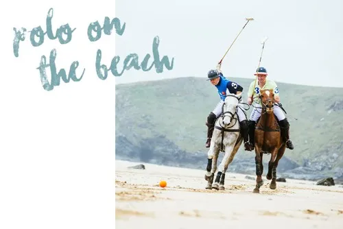 Two men on horses on a beach. 