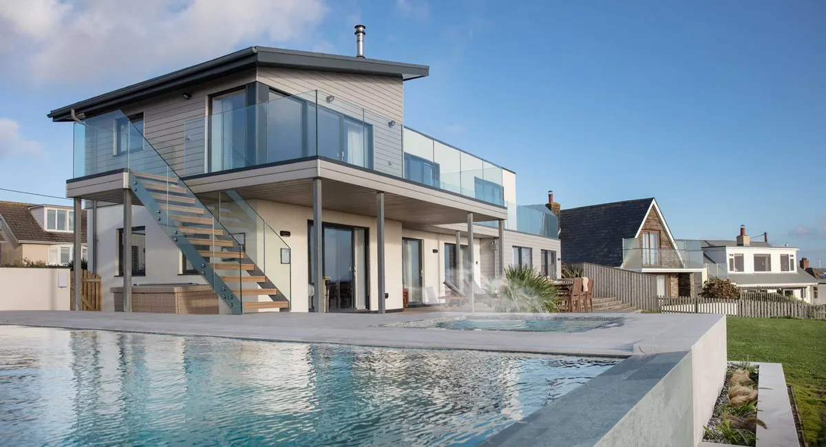 A modern house with a pool and a deck.