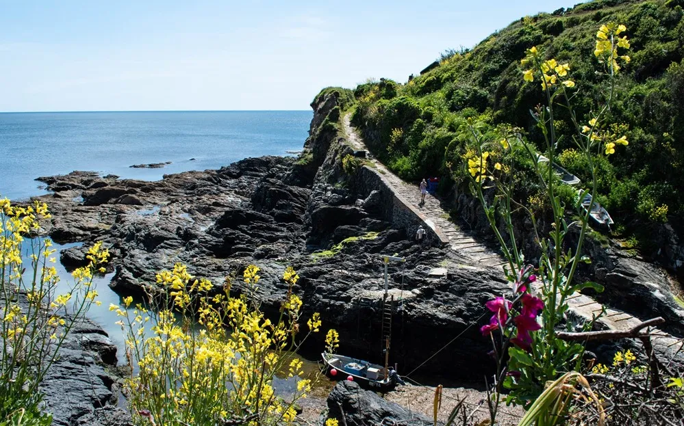 A path on a rocky cliff by the water. 