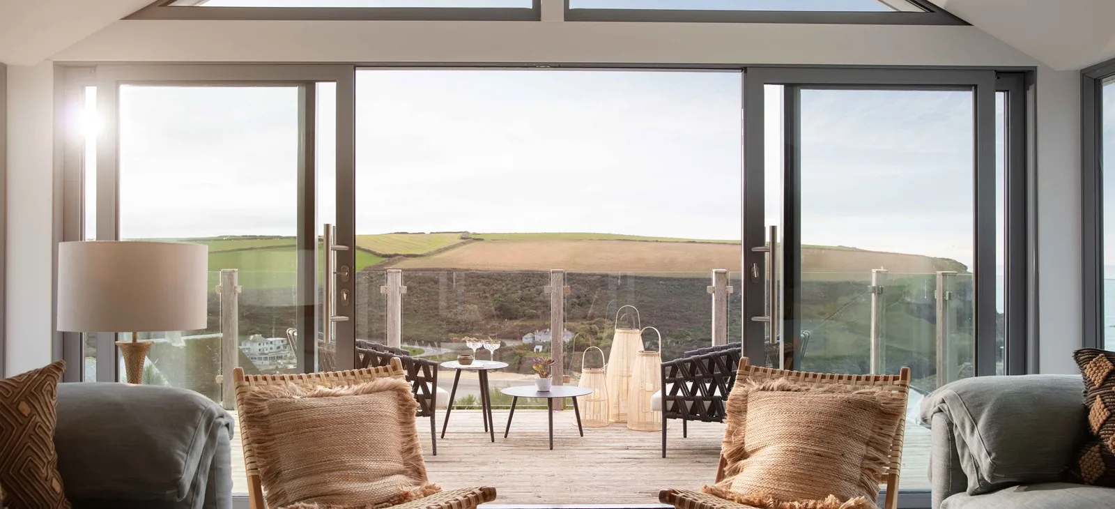 A living area with chairs and a table outside.