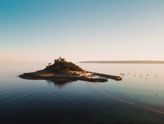 An island with a grand house on it.