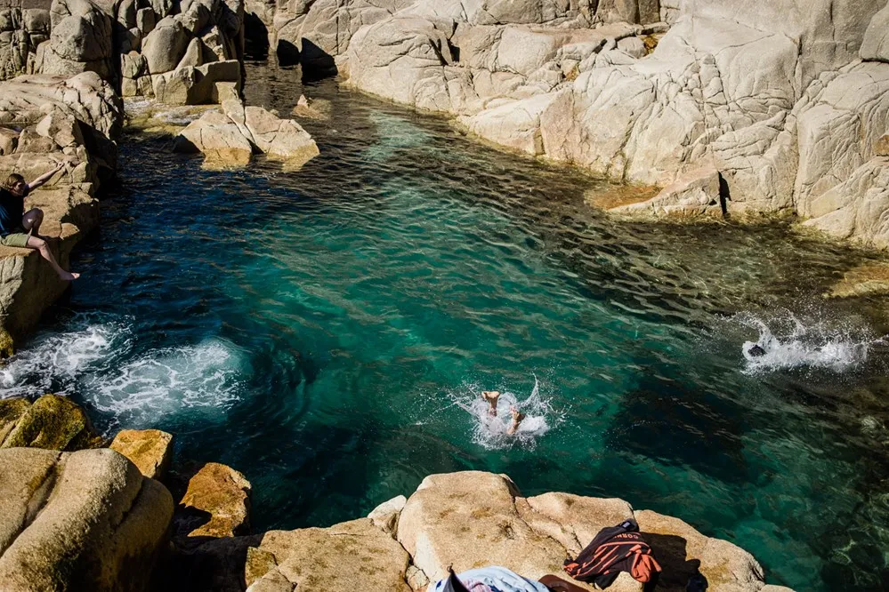 A person jumping into the water.