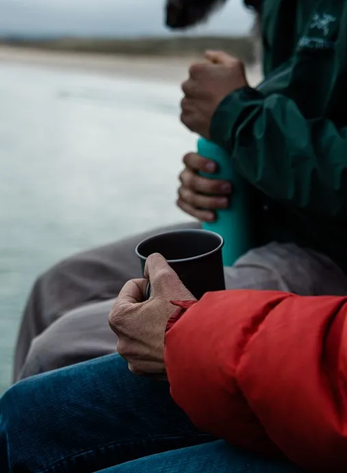 Hands holding a cup.