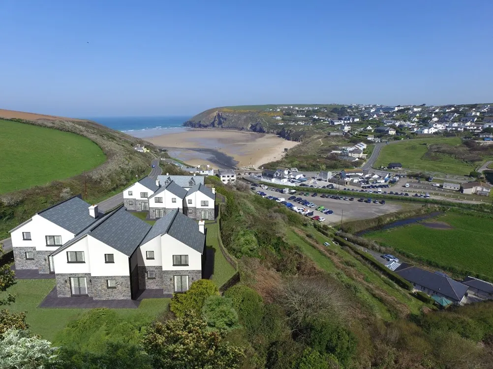 White houses on a hill overlooking the sea.