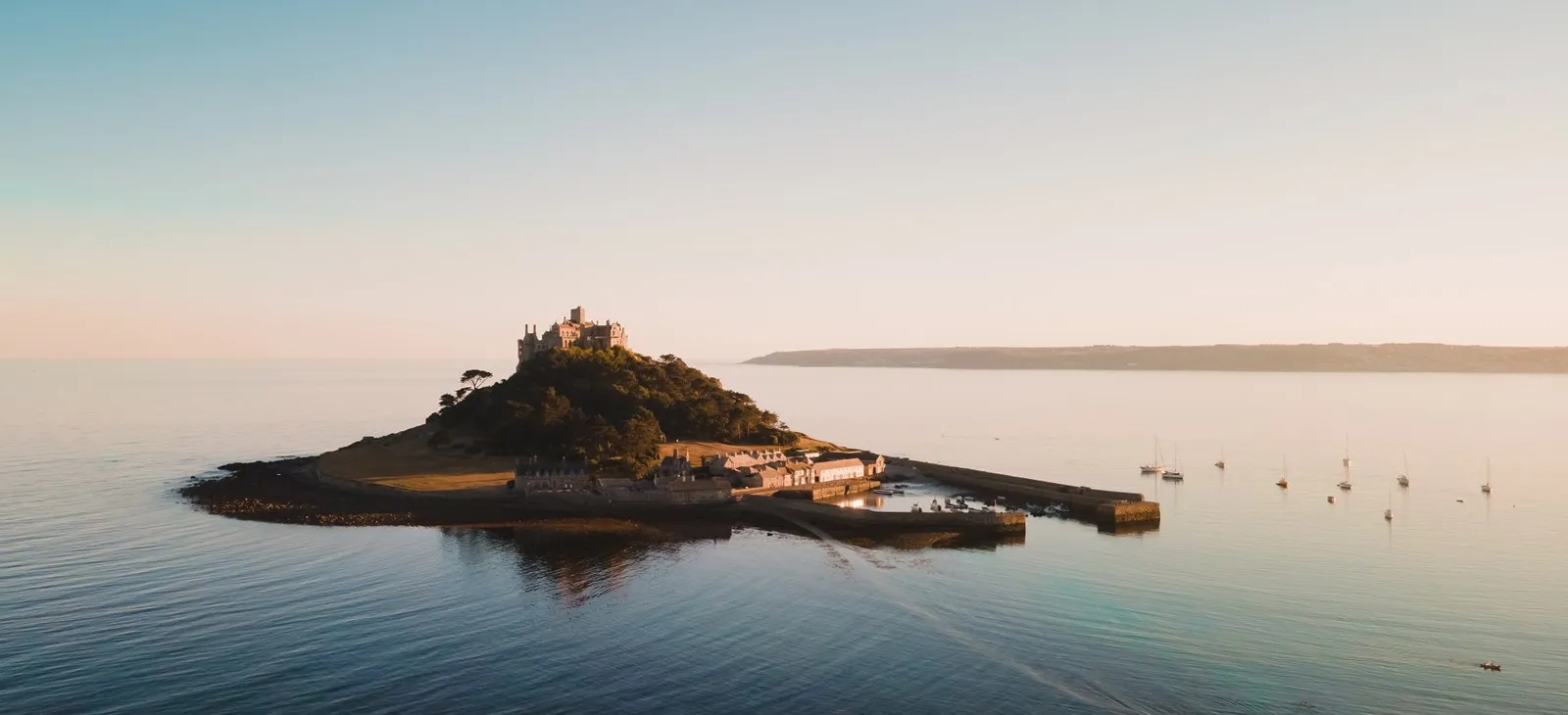 A castle on a small island surrounded by water.