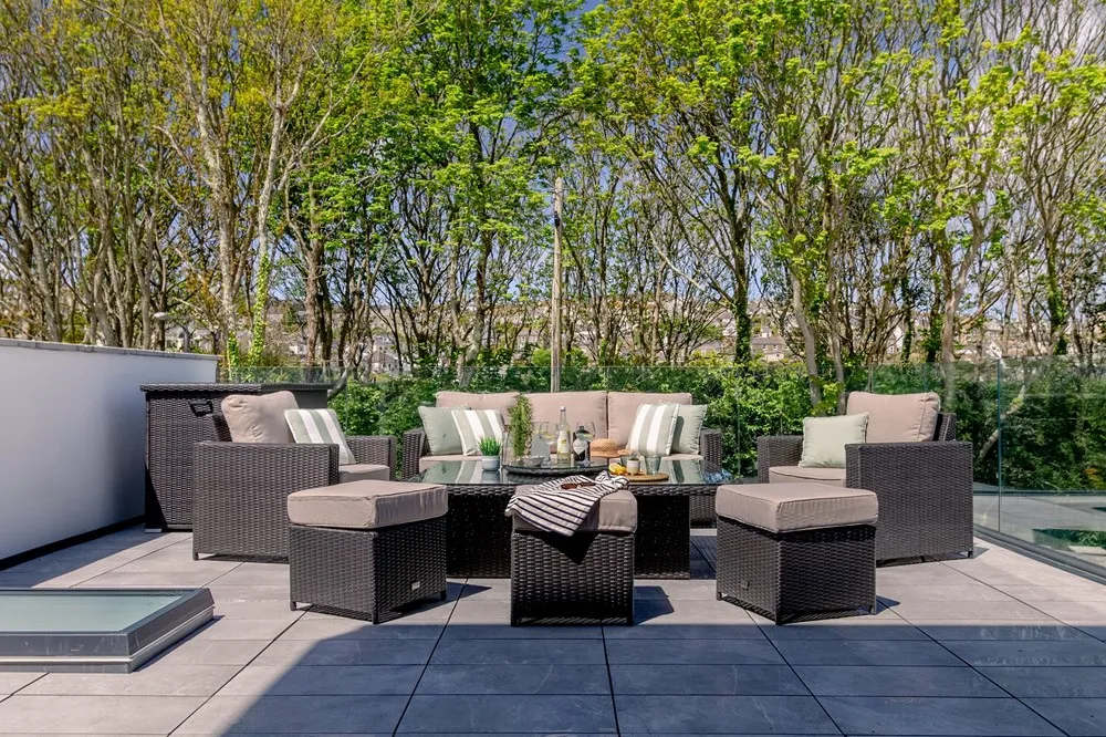 A patio with a table and chairs. 