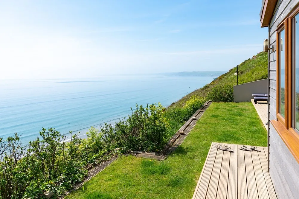 A deck on a hill overlooking the sea. 