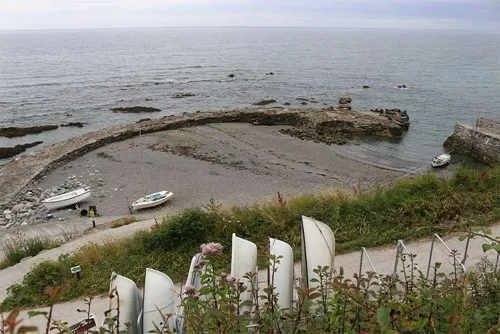 Boats on a beach at low tide.