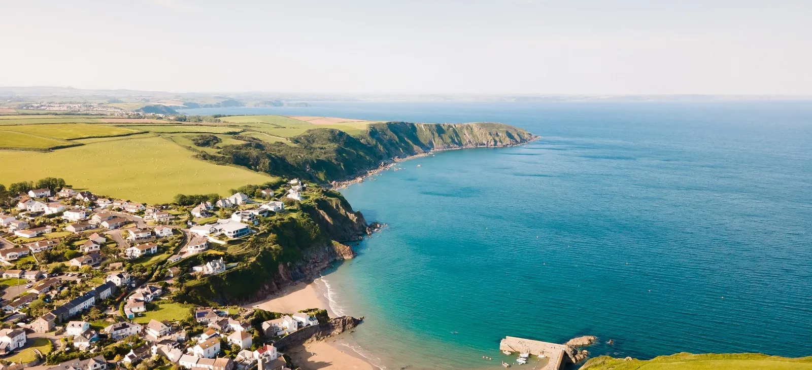 Hilltop town overlooking a secluded beach.