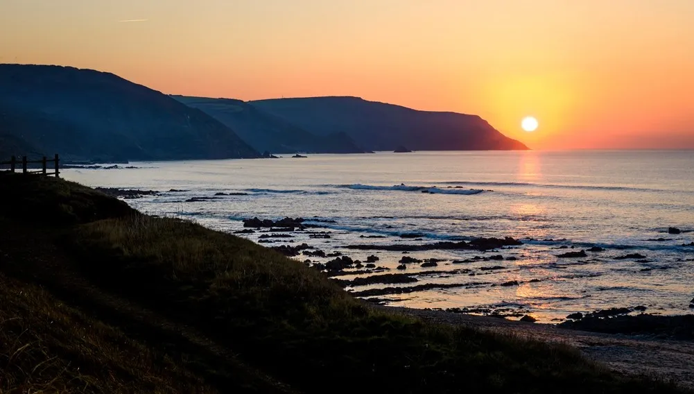 A sunset over a rocky coast.