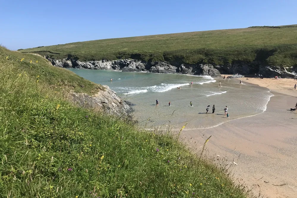 Polly Joke Beach with waves and green cliffs