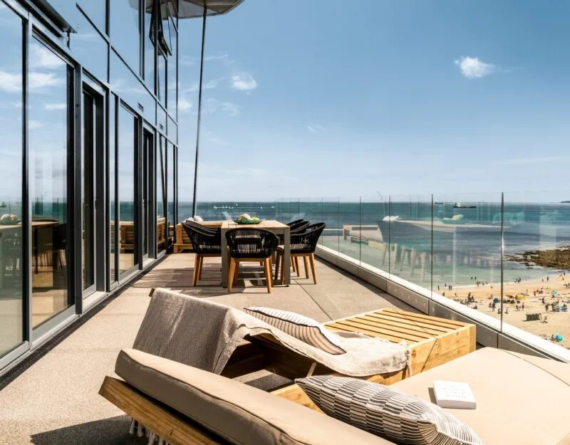 Large balcony with sun loungers overlooking the sea