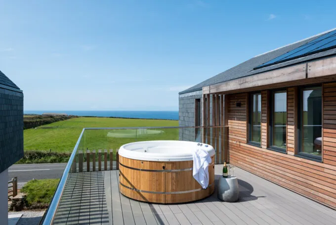 A hot tub on a balcony with a sea view