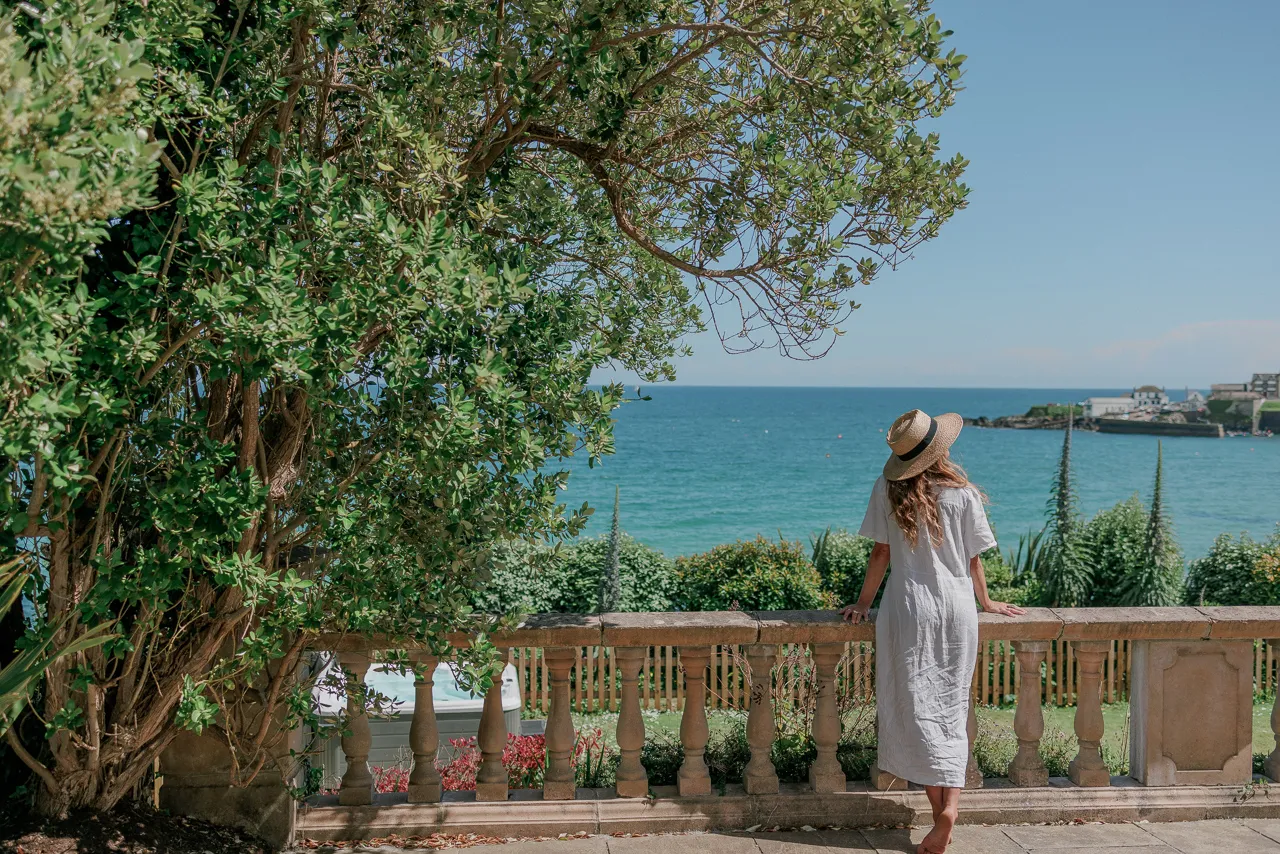 Woman on a balcony with a sea view