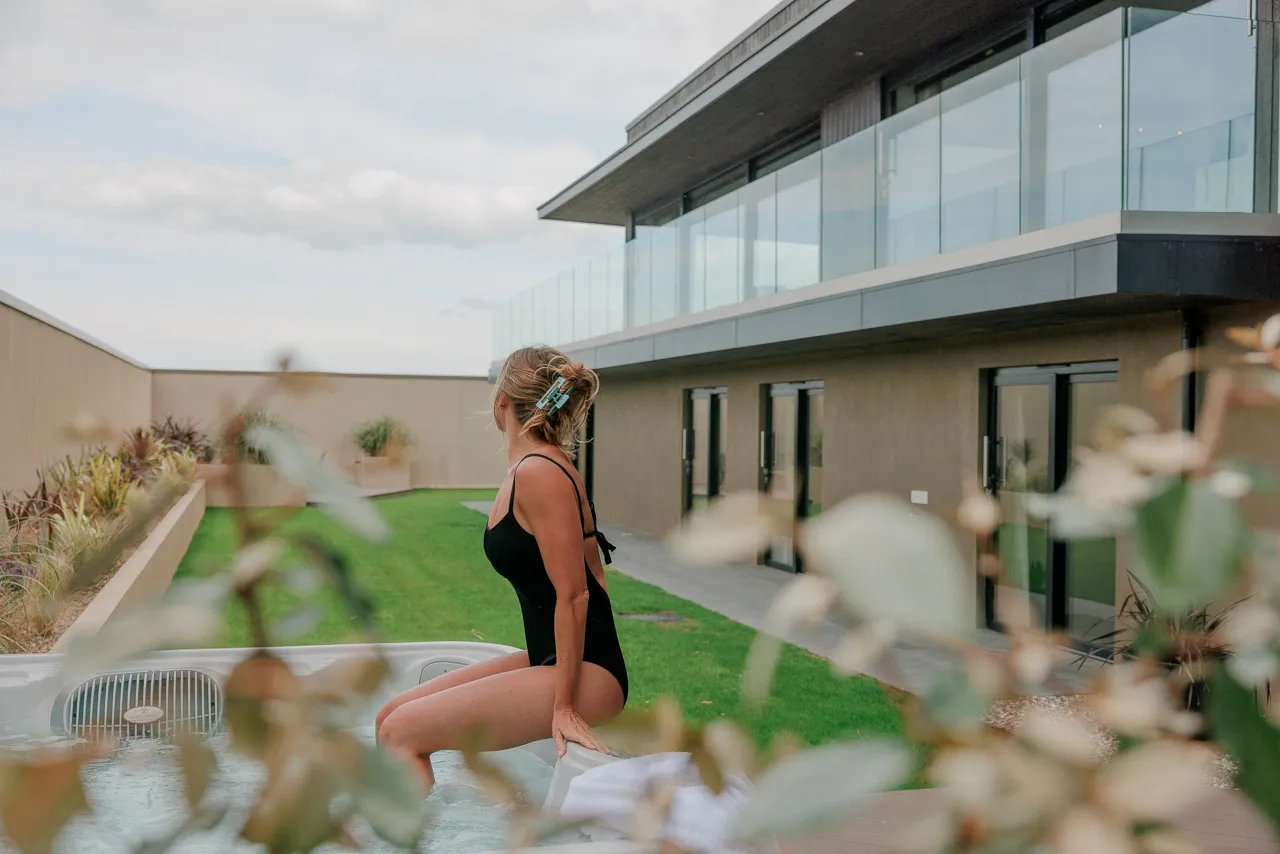 Woman sat in a hot tub at a luxury property