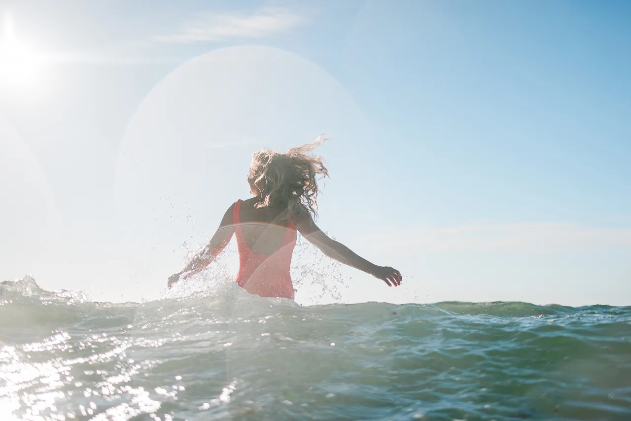 Woman enjoying a sea dip in Cornwall.