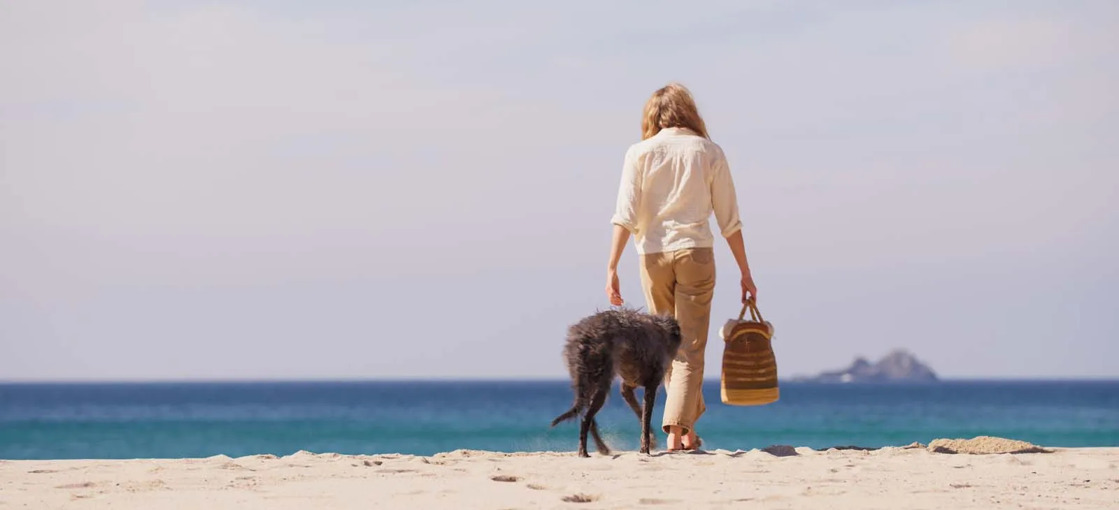 Lady and her dog on the beach at Sennen, Cornwall