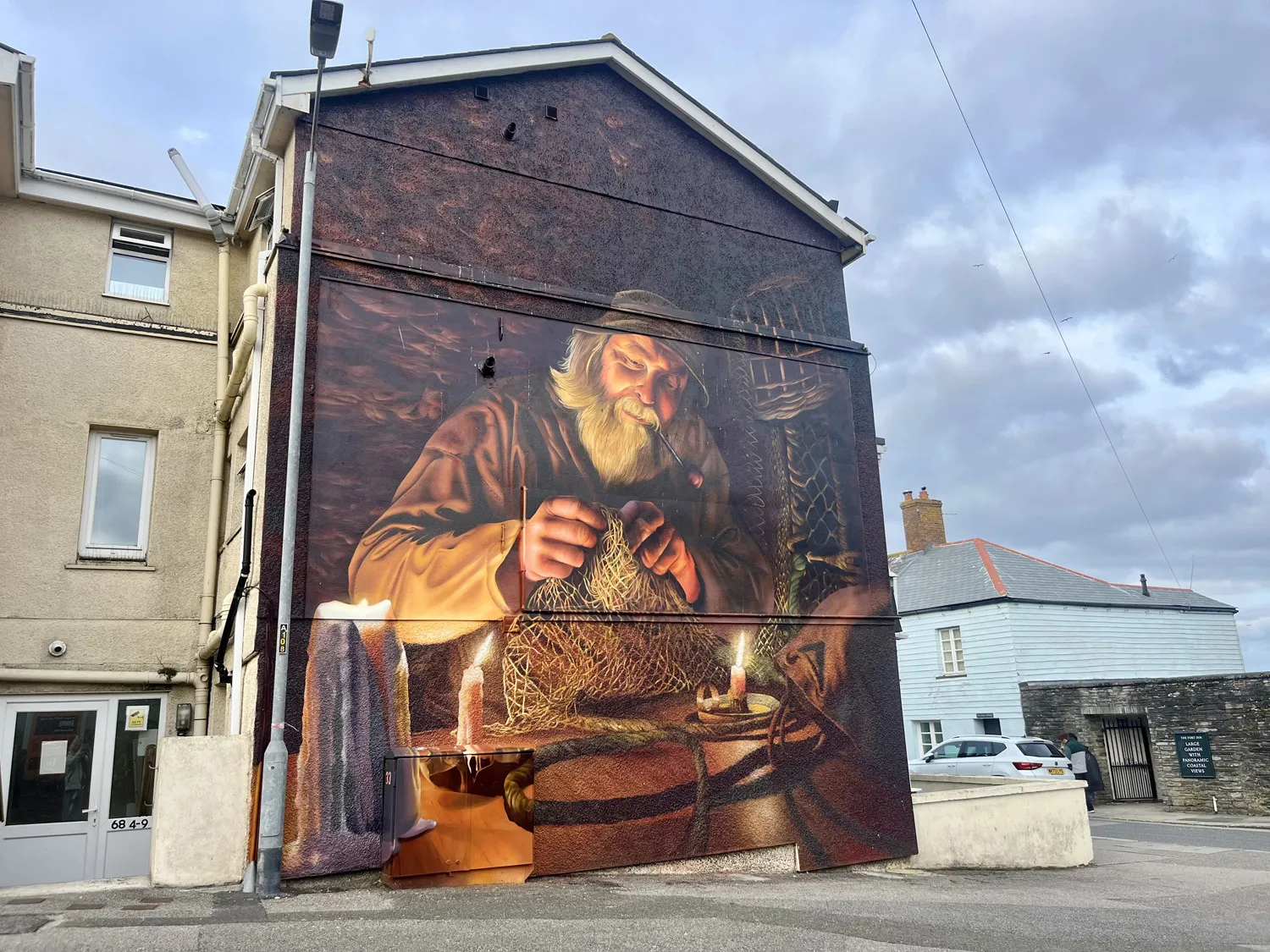 Painting of a fisherman on the side of a building
